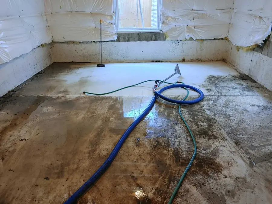 Restoration technician extracting standing water from a flooded Rancho Mirage, CA home