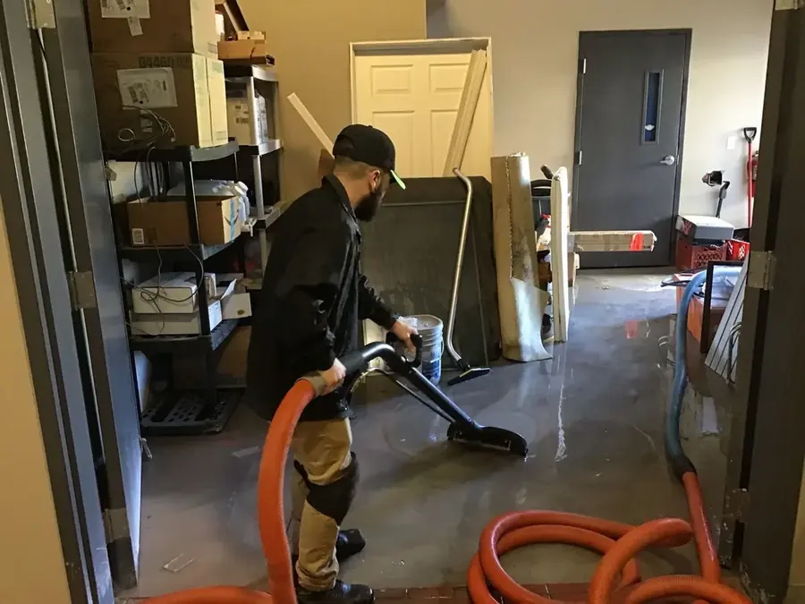 Technician extracting standing water from a Rancho Mirage floor